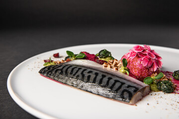 Gourmet and gastronomic fish dish isolated on a black background