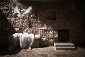 Jesus Christ crucifixion death and resurrection and easter dove flying in a stone tomb
