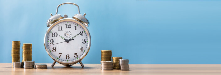 clock with coins on the table