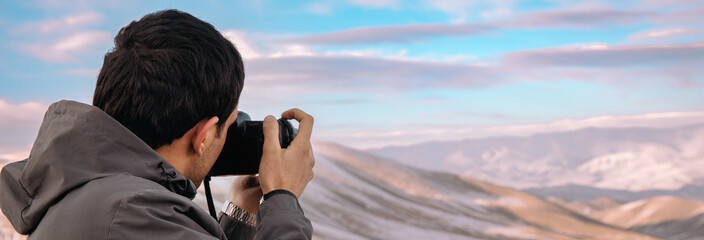 photographer takes a photo of the beautiful mountain