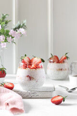 Chia pudding with strawberries. White background, spring flowers.