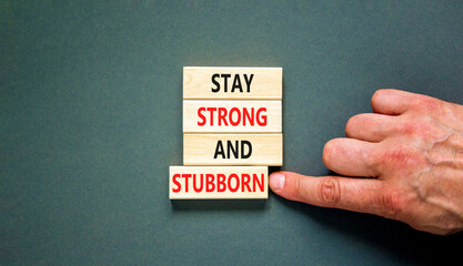 Stay strong and stubborn symbol. Concept words Stay strong and stubborn on wooden block. Beautiful grey table grey background. Motivational business stay strong and stubborn concept. Copy space.