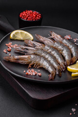Tiger prawn or langoustine raw with spices and salt on a wooden cutting board