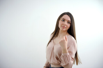 Young business chinese woman pointing with finger at you as if inviting come closer. High quality photo