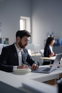 Finance industry. Businessman. Smart suit. Laptop. Trading. Analytics