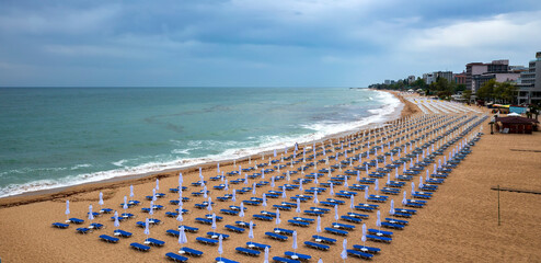Panoramic view of the beach with umbrellas. Sea beach coastline, summer holiday.