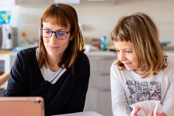 Mother and daughter reviewing homework