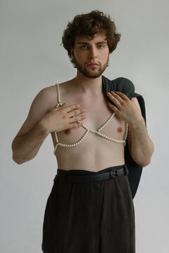 Topples curly guy with pierced nipple wears a pearl bra and a suit