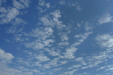 Naklejka na ściany i meble White cirrus clouds. Texture of white clouds on the blue sky. Sunny day.