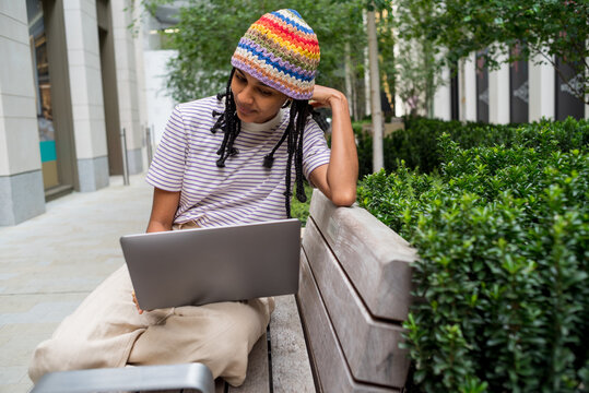 Front portrait of young woman studying outdoors