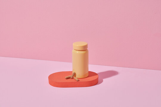 Mockup bottle on color stand with natural bio pills or vitamins