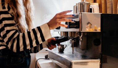 young woman working on coffee machine