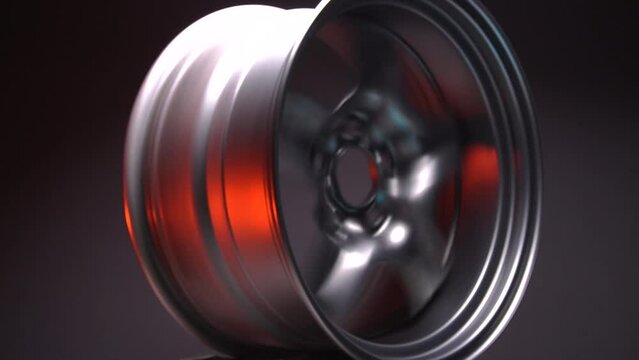 sporty metallic gray car rims extended illuminated by red light long exposure photography for motion blur effect when rotating
