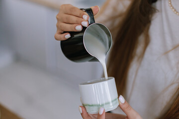 Faceless bartender Pouring Milk into Cup