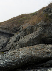 Black Sea coast. A seashore formed by frozen volcanic lava. Tectonic rocks.