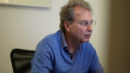 One senior business man working in front of computer screen. Older mature entrepreneur reading content online