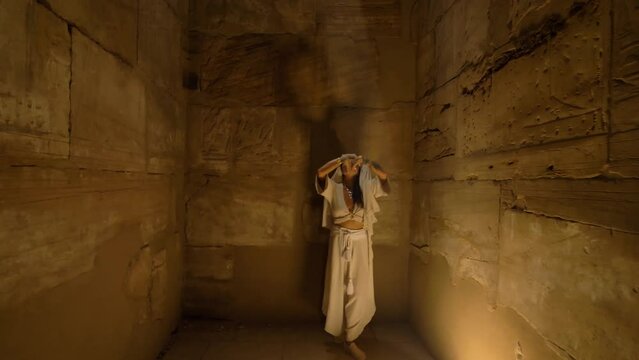 2022 - An interpretive dancer performance through a shaft of sunlight in the Karnak Temple Complex.