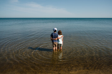 Children hug in waters of Lake Michigan
