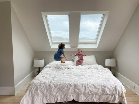 Kids Jumping on the Bed at Home