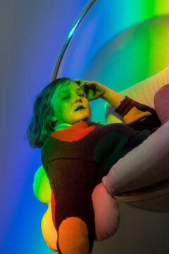 Woman Poses in Colorfully Lit Portrait