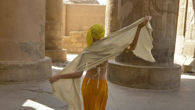 2022 - A modern dancer performs sensuously with a shawl among the columns of Egypt's Temple of Kom Ombo.