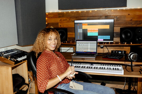 Music producer at home studio looking at camera. Raw ugc direct flash.