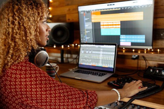 happy Music producer working at home studio using midi pad controller