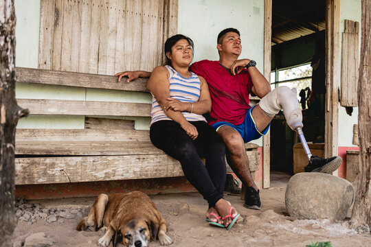 Couple sitting outside their home