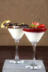 Traditional italian dessert tiramisu in a glass. sprinkle the cocoa powder over the tiramisu. pours cocoa cream powder condensed milk chocolate and berries