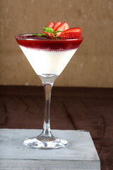 Traditional italian dessert tiramisu in a glass. sprinkle the cocoa powder over the tiramisu. pours cocoa cream powder condensed milk chocolate and berries