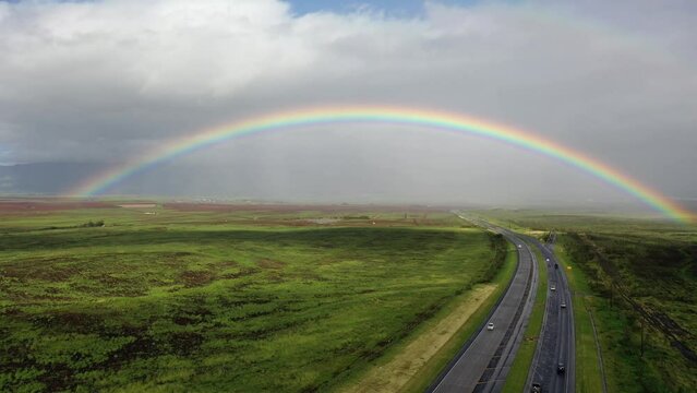 2022 - Excellent aerial footage of a rainbow spanning a road in Maui.