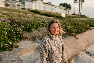 Smiling tween girl outdoors at sunset in southern california