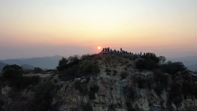 2022 - Excellent aerial footage of hikers on a mountaintop at sunset in Topanga Canyon.