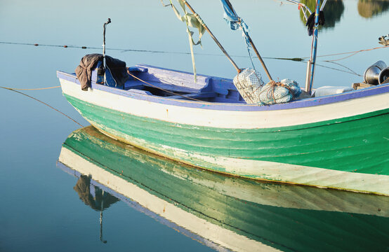Old colourful boat in in calm waters