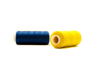 blue and yellow spools of thread on white background. Ukrainian motif