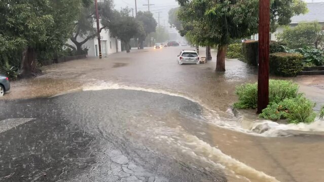 2023 - A suburban street is flooded in Santa Barbara, California during a heavy rainstorm.