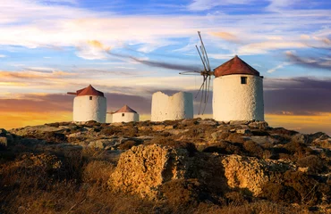 Foto op Canvas Traditional typical  greek windmills. Amorgos island in Cyclades, Chora village over sunset © Freesurf