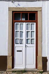 White wooden door in Alcochete town in Portugal