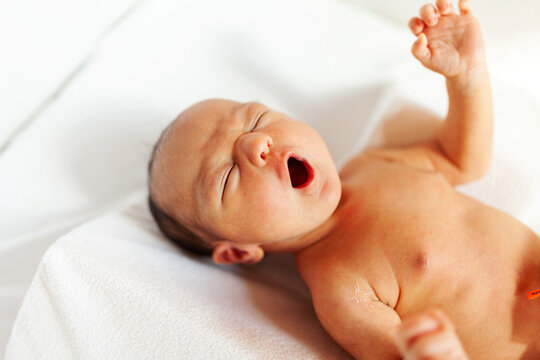Baby crying on bed