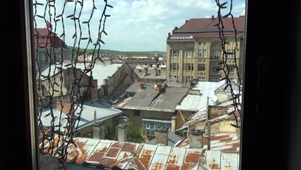 2022 - establishing shot of Lviv, Ukraine through the window of an old building.