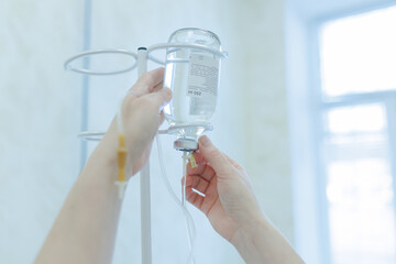 doctor preparing drip system for patient