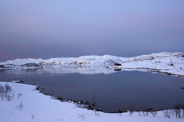 Fototapeta na wymiar landscape sunset in snowy nature and sea in tromso