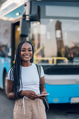 Portrait of an african american woman waiting public transportation on a bus stop