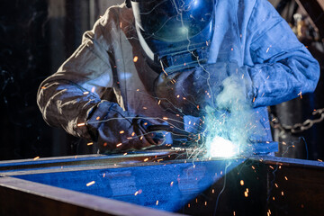 welder works with metal, mechanical engineering concept