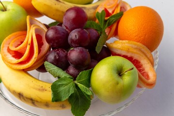 Obraz na płótnie Canvas Grape apple banana on a plate