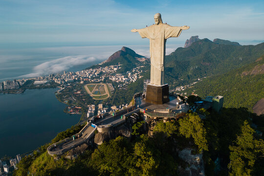 Rio de Janeiro, Brazil - March 21, 2023: Christ the Redeemer statue on top of the Corcovado mountain with Rodrigo de Freitas lagoon below.