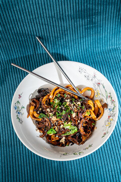 Asian noodle udon in dish on green