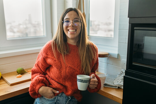 Portrait of Pretty Smiling Woman With Glasses Holding Cup