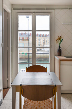 Kitchen with a small table two chairs view of river and the port 