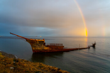 Lord Lonsdale shipwreck with rainbow at dusk in the coast of Punta Arenas, Chile. The Lord Lonsdale...